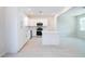 Bright kitchen featuring white cabinets, stainless steel appliances, and a central island at 1039 Morningside Dr, Eustis, FL 32726