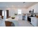 Bright kitchen featuring white cabinets, stainless steel appliances, and a central island at 1039 Morningside Dr, Eustis, FL 32726
