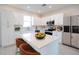 Bright kitchen featuring white cabinets, stainless steel appliances, and a central island at 1039 Morningside Dr, Eustis, FL 32726