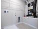 A well-lit laundry room with a utility sink and storage space at 1039 Morningside Dr, Eustis, FL 32726