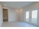 Bright, empty room featuring a double glass door to the backyard at 1039 Morningside Dr, Eustis, FL 32726