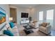 Bright living room features neutral walls, comfortable seating, and contemporary decor at 1039 Morningside Dr, Eustis, FL 32726