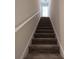 Carpeted stairs lead to the upper level of this bright home at 1039 Morningside Dr, Eustis, FL 32726