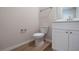 Modern half bathroom with sleek fixtures and white cabinets and a wood floor at 1045 Morningside Dr, Eustis, FL 32726