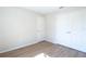 Clean, neutral bedroom with light wood flooring and a double door closet at 1045 Morningside Dr, Eustis, FL 32726