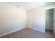 Clean bedroom with light wood flooring and access to an open closet at 1045 Morningside Dr, Eustis, FL 32726