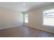 Empty bedroom with light walls, new wood-look flooring and two windows at 1045 Morningside Dr, Eustis, FL 32726