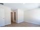 Empty bedroom with light walls, new wood-look flooring and an en-suite bathroom at 1045 Morningside Dr, Eustis, FL 32726