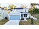 Charming two-story home boasts a well-manicured lawn and light blue garage door, enhancing its curb appeal at 1045 Morningside Dr, Eustis, FL 32726