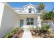 Inviting front entrance featuring a light blue door, lush landscaping, and a welcoming walkway at 1045 Morningside Dr, Eustis, FL 32726