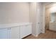 Hallway leading to a bathroom with a modern white vanity and sink at 1045 Morningside Dr, Eustis, FL 32726