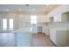 Spacious kitchen with white cabinets, countertops, and a functional center island, ideal for modern living at 1045 Morningside Dr, Eustis, FL 32726
