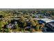 An aerial shot showcases the neighborhood, surrounded by lush greenery and a mix of residential and commercial buildings at 1045 Morningside Dr, Eustis, FL 32726