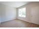 Bright empty room featuring wood floors, a large window and a door at 1045 Morningside Dr, Eustis, FL 32726