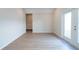 Large vacant room featuring wood floors and a glass paned door to the exterior at 1045 Morningside Dr, Eustis, FL 32726