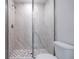 Glass shower with white marble-style tiles and mosaic flooring at 1045 Morningside Dr, Eustis, FL 32726