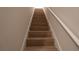 Stairway with wood-look steps and a white handrail at 1045 Morningside Dr, Eustis, FL 32726