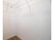 Bright walk-in closet features a wire shelving system and wood-look floors at 1045 Morningside Dr, Eustis, FL 32726