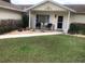 Charming home exterior featuring a cozy front porch with seating and manicured landscaping at 10839 Sw 78Th Ct, Ocala, FL 34476