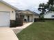 Charming single-story home with a well-manicured lawn, covered porch, and attached garage at 10839 Sw 78Th Ct, Ocala, FL 34476