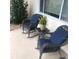 Relaxing front porch with cushioned rocking chairs, side table, and view of the neighborhood at 10839 Sw 78Th Ct, Ocala, FL 34476
