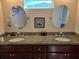 Bathroom with a granite countertop, dual sinks, modern faucets, and oval mirrors at 1090 Parnell Ct, Deltona, FL 32738