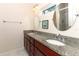 Bathroom featuring dual sinks with wood cabinets and granite countertops at 1090 Parnell Ct, Deltona, FL 32738