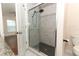 Bathroom with glass-enclosed shower showcasing gray tile with a black mosaic border and black shower floor at 1090 Parnell Ct, Deltona, FL 32738