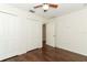 Bedroom with wood-look flooring, ceiling fan, and closet at 1090 Parnell Ct, Deltona, FL 32738