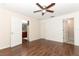 Large bedroom with hardwood floors and access to both the kitchen and bathroom at 1090 Parnell Ct, Deltona, FL 32738
