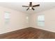 Comfortable bedroom with ceiling fan, hardwood flooring, and bright natural light at 1090 Parnell Ct, Deltona, FL 32738