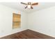 Bedroom with wood-look flooring, ceiling fan, and a window at 1090 Parnell Ct, Deltona, FL 32738