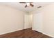 Bright bedroom featuring wood-look floors, ceiling fan, and closet with bi-fold doors at 1090 Parnell Ct, Deltona, FL 32738