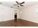 Spacious bedroom featuring a ceiling fan, hardwood floors, and an ensuite bathroom at 1090 Parnell Ct, Deltona, FL 32738