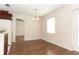 Dining area featuring wood-style flooring, natural light, and easy access to the kitchen at 1090 Parnell Ct, Deltona, FL 32738