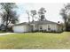 Charming single-story home with a well-manicured lawn and attached two car garage at 1090 Parnell Ct, Deltona, FL 32738
