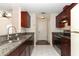 Updated kitchen with stainless steel appliances, granite countertops, and dark wood cabinets at 1090 Parnell Ct, Deltona, FL 32738