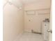 Laundry room with overhead shelving, tiled floor, and washer at 1090 Parnell Ct, Deltona, FL 32738