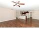 Open concept living area that features hardwood floors and a modern ceiling fan at 1090 Parnell Ct, Deltona, FL 32738