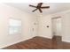 Bright living room with hardwood floors, a ceiling fan, and natural light from a window at 1090 Parnell Ct, Deltona, FL 32738