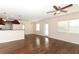 Open-concept layout connecting the living room, dining area and kitchen, featuring hardwood flooring at 1090 Parnell Ct, Deltona, FL 32738