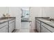 Beautiful bathroom with gray vanities, granite countertops, and view into a bedroom at 1128 Clay Blvd, Tavares, FL 32778