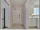 An entryway featuring a white door, tile flooring, and access to the laundry room and closet at 11778 Fan Tail Ln, Orlando, FL 32827