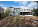 Exterior view of home showcasing the backyard, screen patio, and landscaping at 1262 Stonewater Cir, Ocoee, FL 34761
