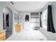 Bright bathroom with a walk-in shower, vanity, and decorative mirror with light tile floors at 1262 Stonewater Cir, Ocoee, FL 34761