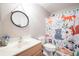 Charming bathroom featuring a playful shower curtain, mirror and modern vanity at 1262 Stonewater Cir, Ocoee, FL 34761