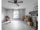 Inviting bedroom features stylish grey floors, a ceiling fan, and a comfortable chair near the window at 1262 Stonewater Cir, Ocoee, FL 34761