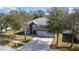 Well-kept two-story home with a spacious driveway, three-car garage, and lush landscaping at 1262 Stonewater Cir, Ocoee, FL 34761