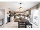 Open kitchen with white cabinets, stainless steel appliances, and access to the patio at 1262 Stonewater Cir, Ocoee, FL 34761