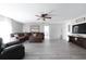 Spacious living room boasts modern flooring, comfy seating, and large TV perfect for movie nights at 1262 Stonewater Cir, Ocoee, FL 34761